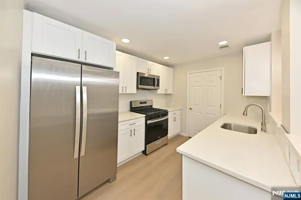 a kitchen with a refrigerator sink and stainless steel appliances