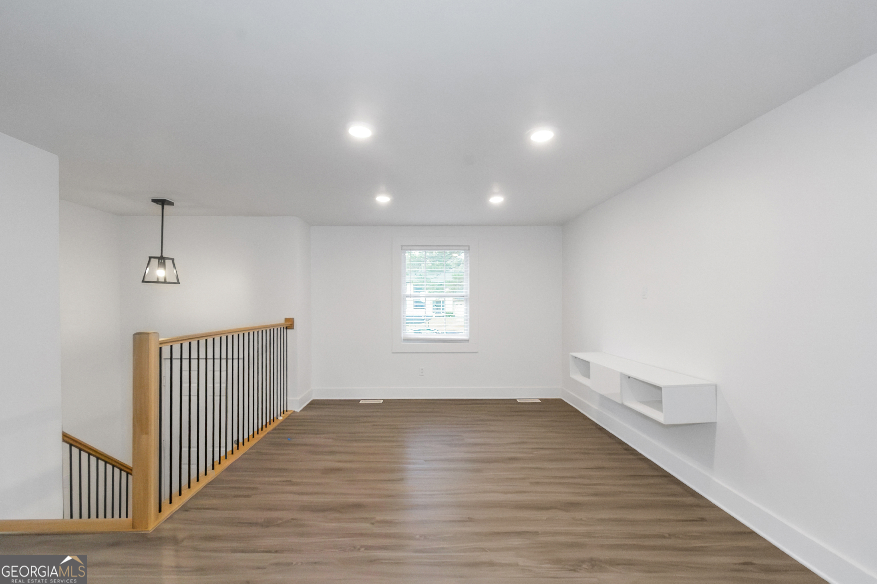 7600 Suwannee Court Jonesboro, GA 30236 - Photo 13 of 35 a view of an empty room with wooden floor and a window