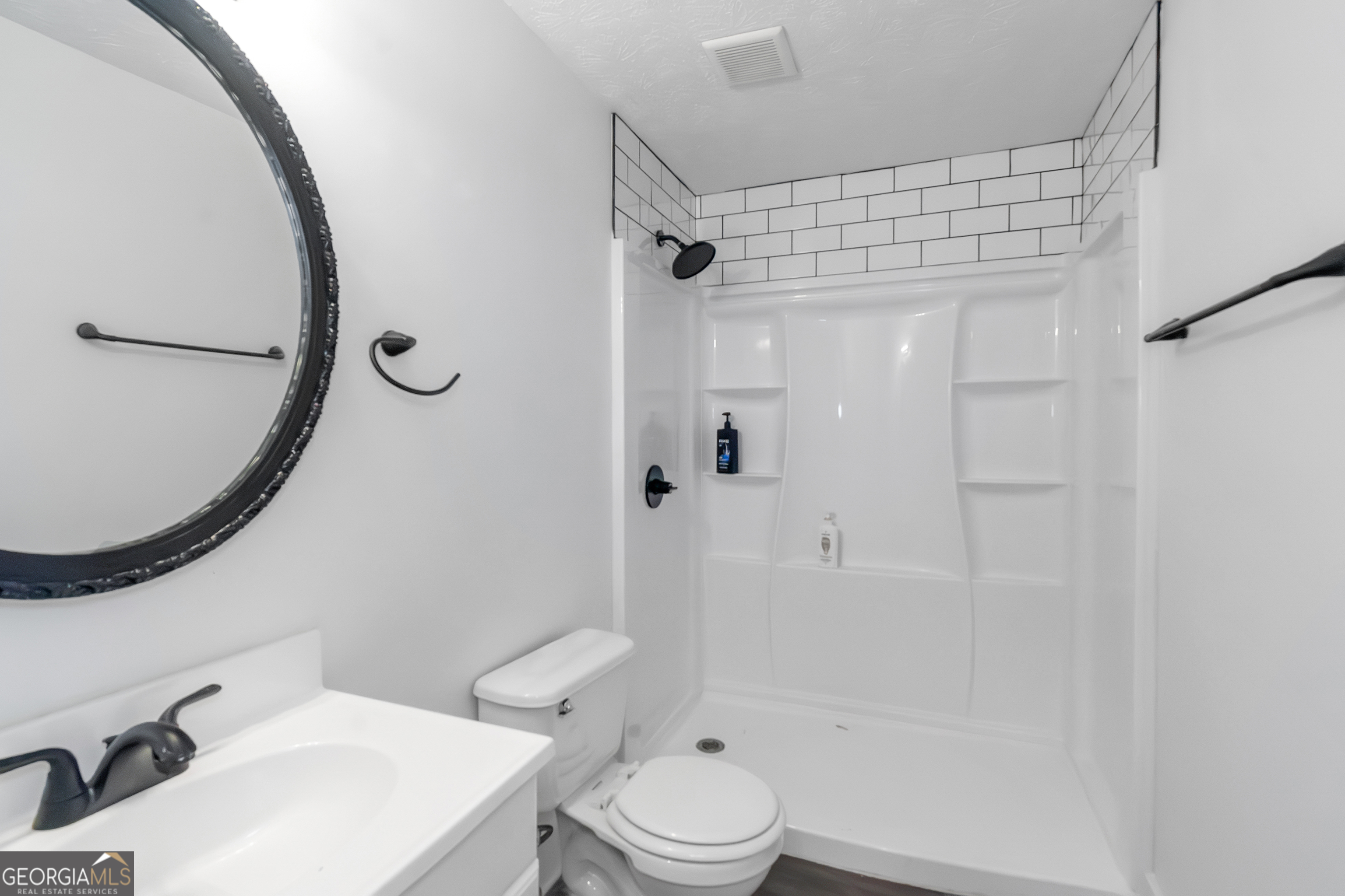 7600 Suwannee Court Jonesboro, GA 30236 - Photo 14 of 35 a bathroom with a sink toilet and shower