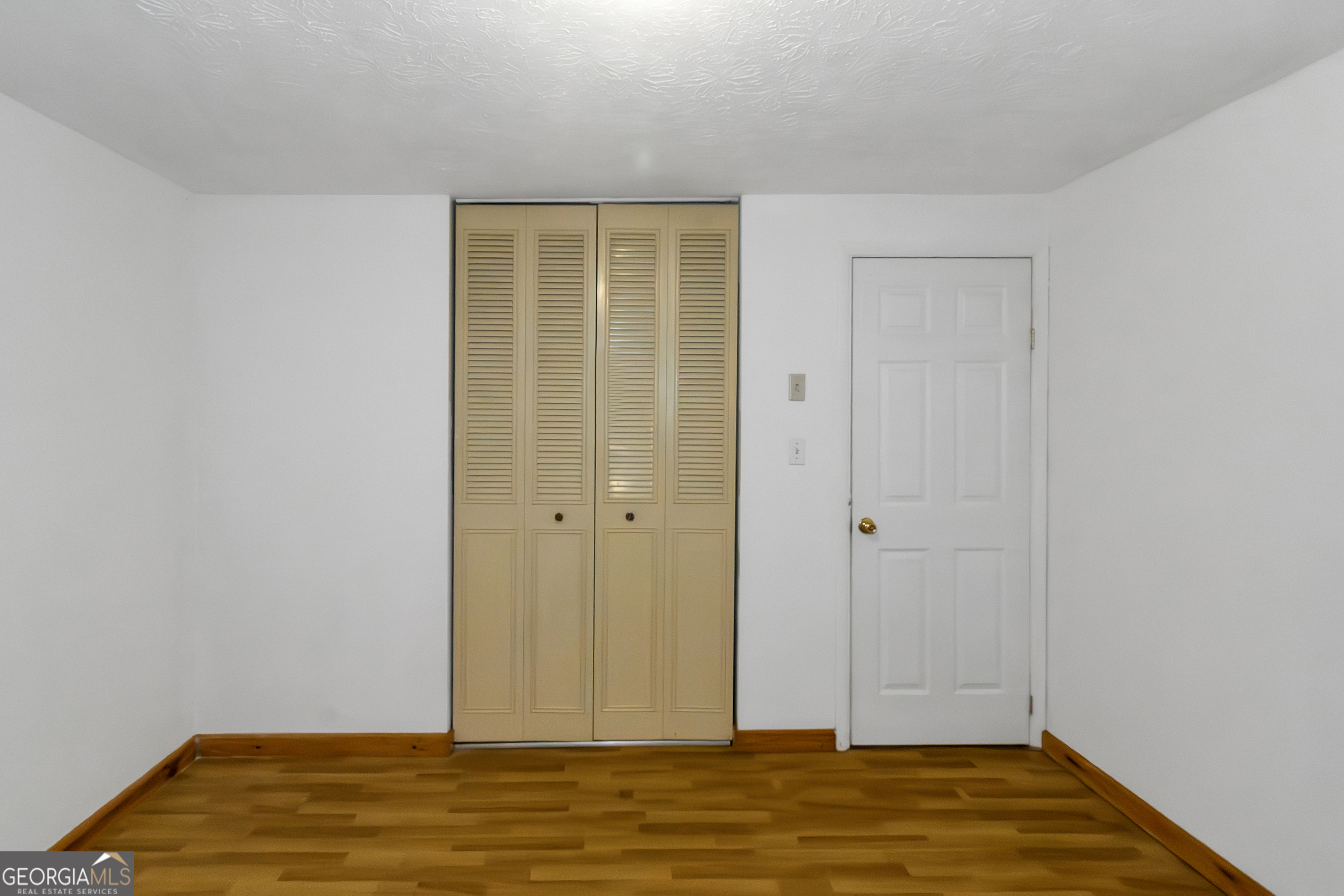7600 Suwannee Court Jonesboro, GA 30236 - Photo 17 of 35 a view of room with wooden floor