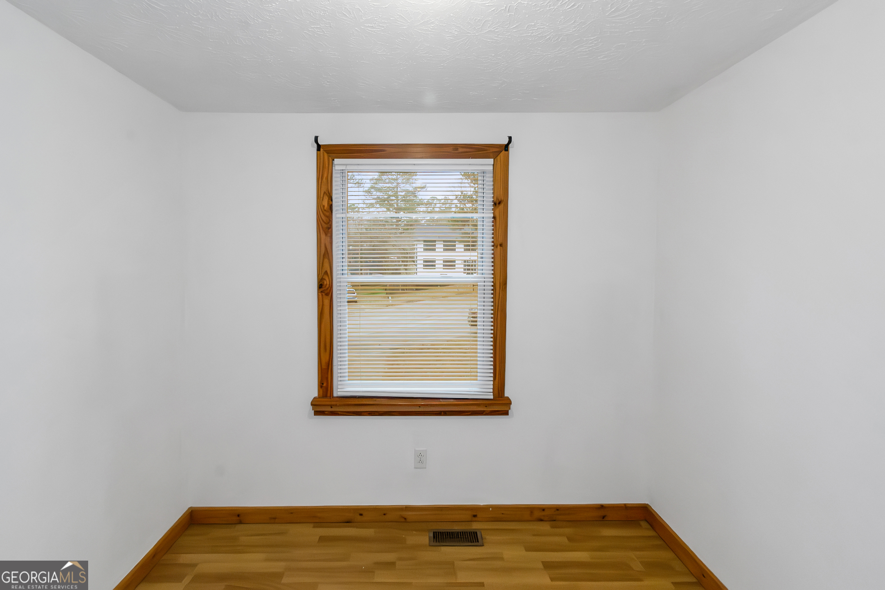 7600 Suwannee Court Jonesboro, GA 30236 - Photo 19 of 35 a view of a room with window and wooden floor