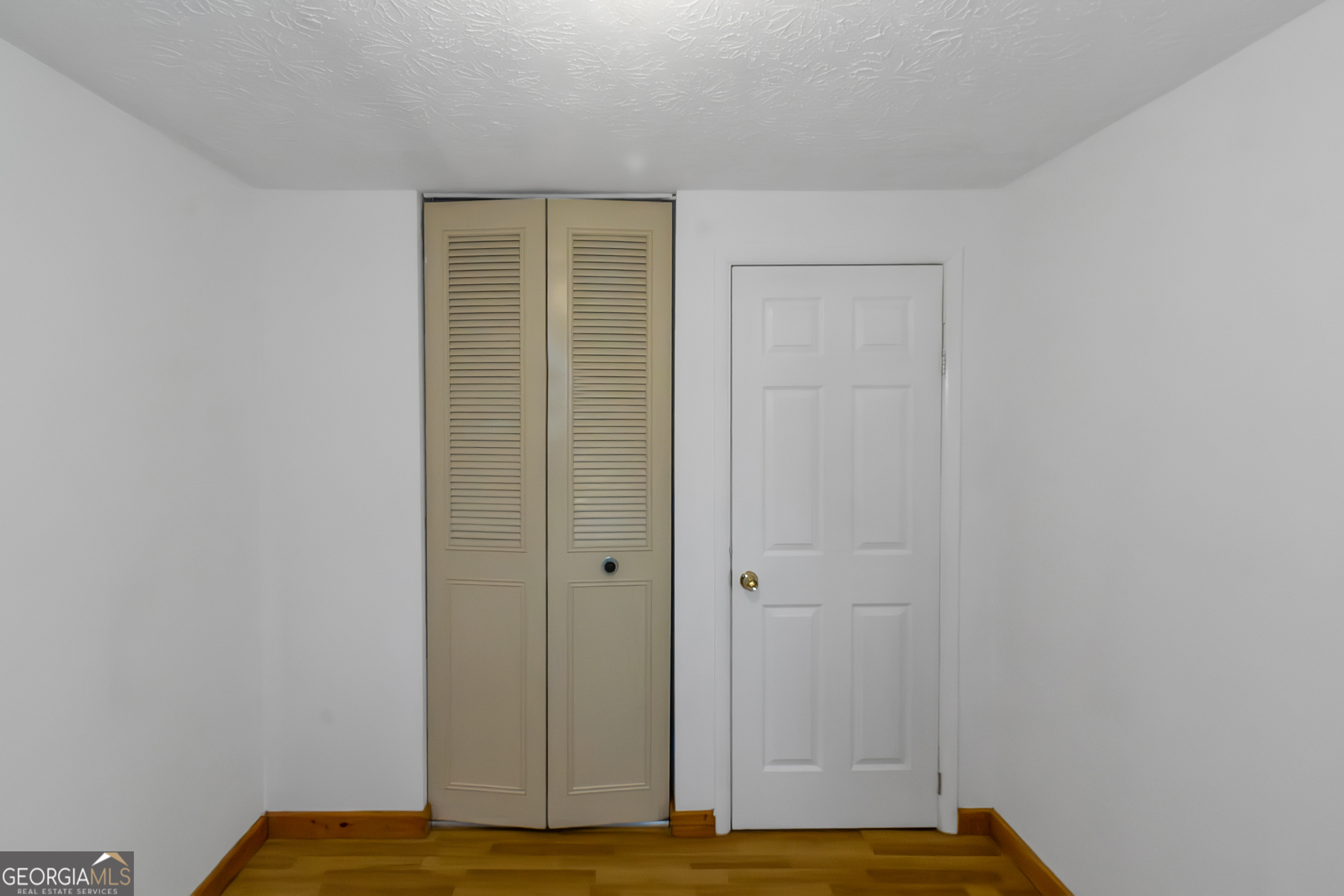 7600 Suwannee Court Jonesboro, GA 30236 - Photo 20 of 35 a view of room with wooden floor