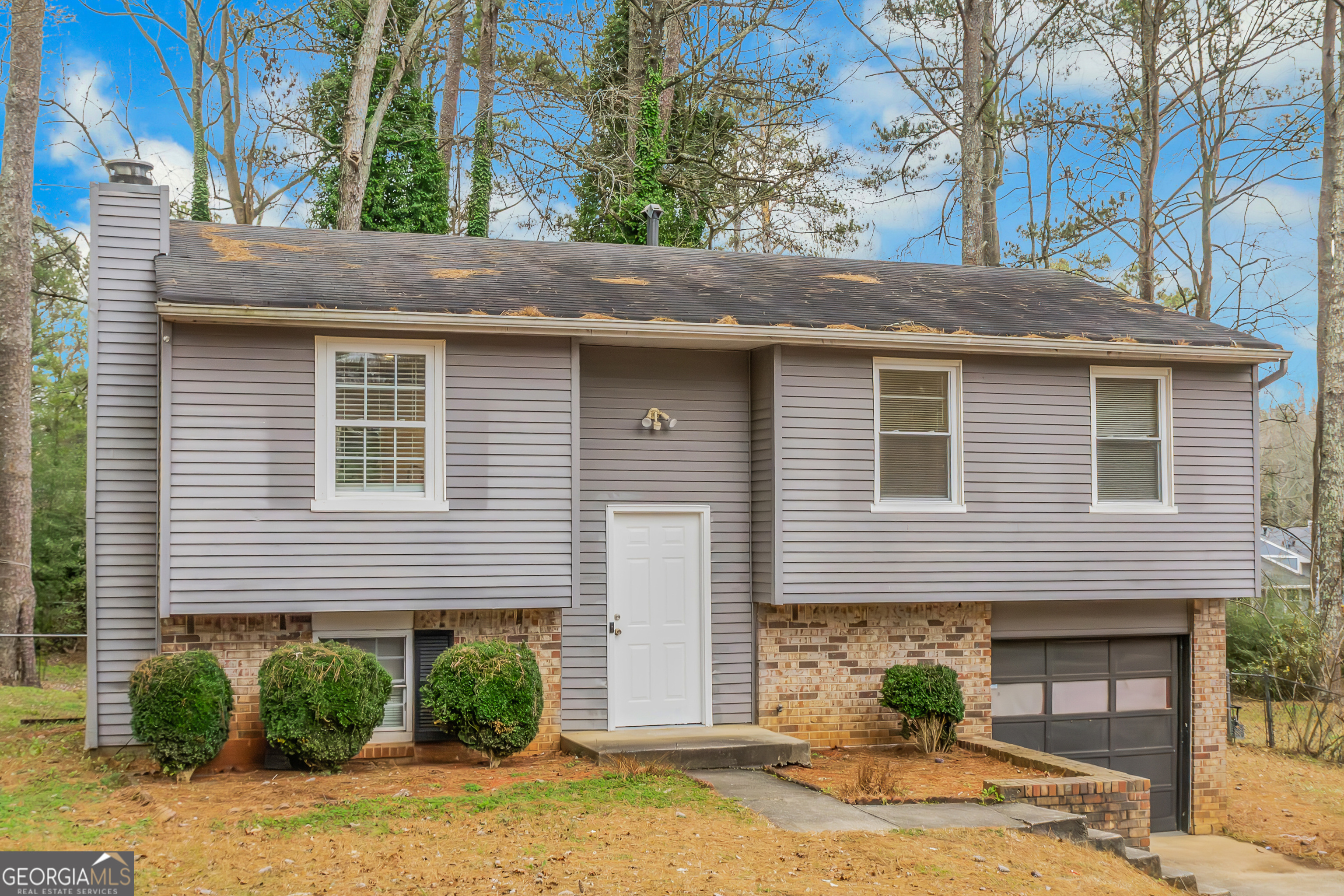 7600 Suwannee Court Jonesboro, GA 30236 - Photo 2 of 35 a front view of a house with garden