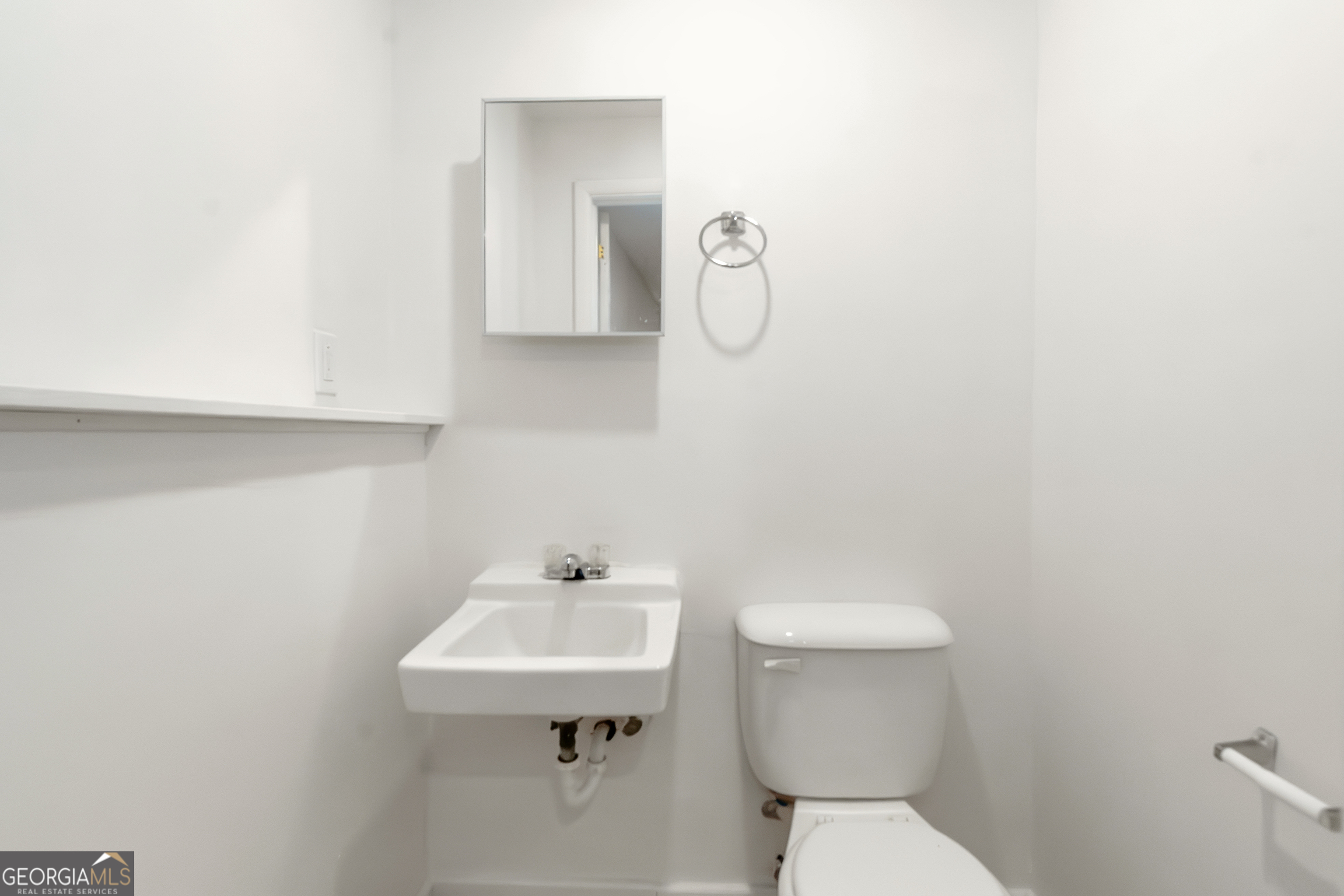 7600 Suwannee Court Jonesboro, GA 30236 - Photo 29 of 35 a bathroom with a sink a toilet and mirror