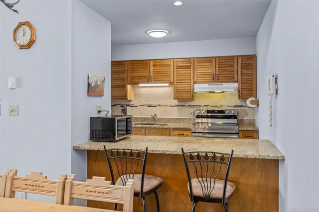 a kitchen with stainless steel appliances a stove a sink dishwasher and a microwave