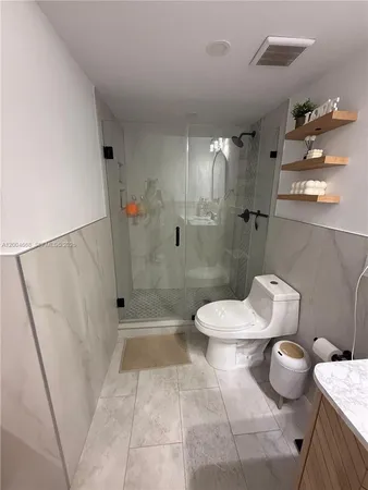 a bathroom with a toilet and a shower