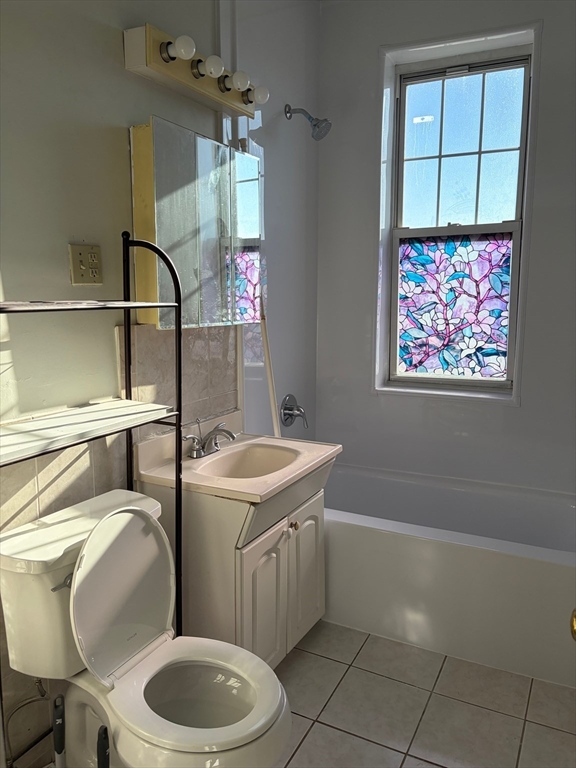 1691 Commonwealth Avenue, Unit 29 Boston, MA 02135 - Photo 5 of 8 a bathroom with a toilet sink and mirror