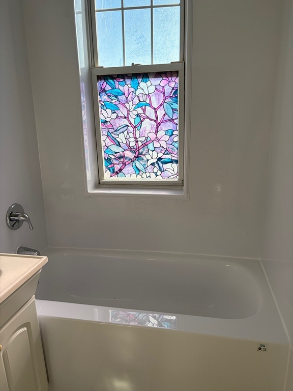 1691 Commonwealth Avenue, Unit 29 Boston, MA 02135 - Photo 6 of 8 a bathroom with a bathtub and a shower