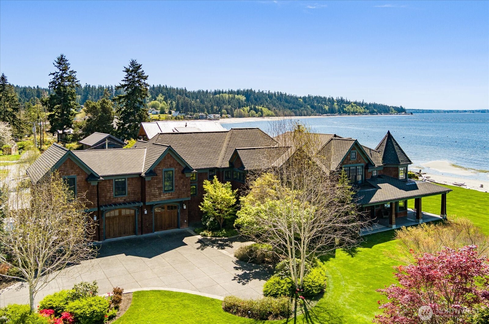 an aerial view of a house with a garden and lake view