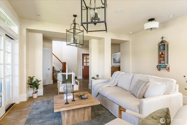 a living room with fireplace furniture and a chandelier
