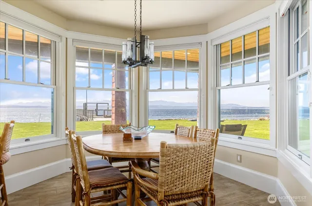 a kitchen with a stove a sink a dining table and chairs