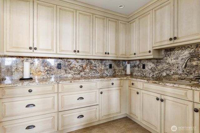 a living room with furniture a fireplace and a large window