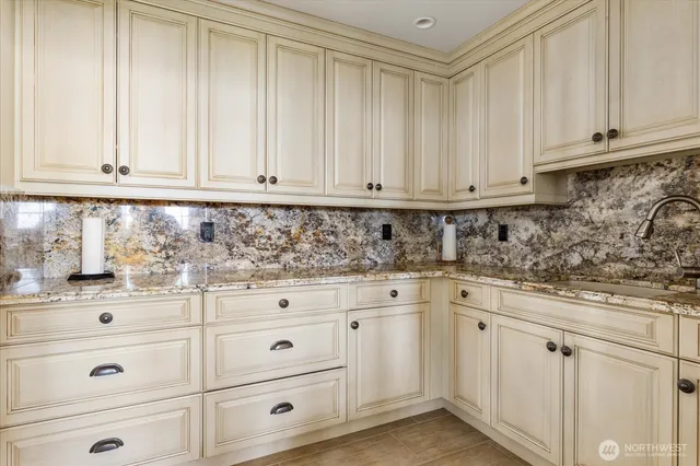a living room with furniture a fireplace and a large window