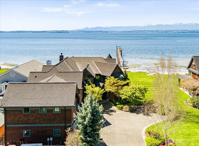 a view of a swimming pool with a garden and lake view