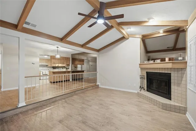 a view of a livingroom with an empty space and a fireplace