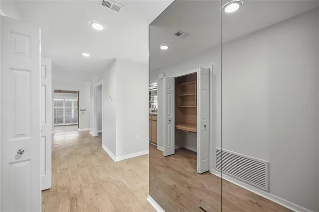 a view of an empty room and closet area