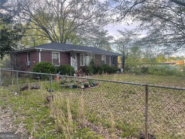 a backyard of a house with yard and outdoor seating