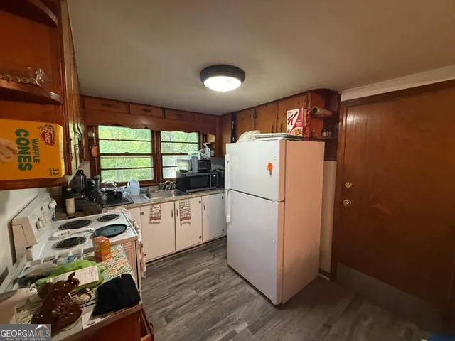 a refrigerator freezer sitting inside of a kitchen