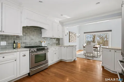 a kitchen with wooden floors and white appliances