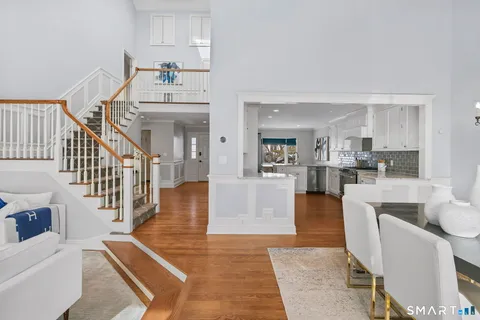 a living room with furniture and kitchen view