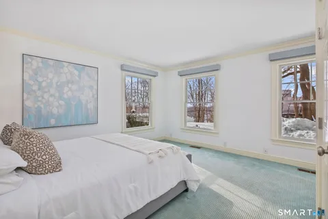 a bedroom with a large bed and a window