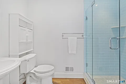 a white toilet sitting next to a bathroom sink