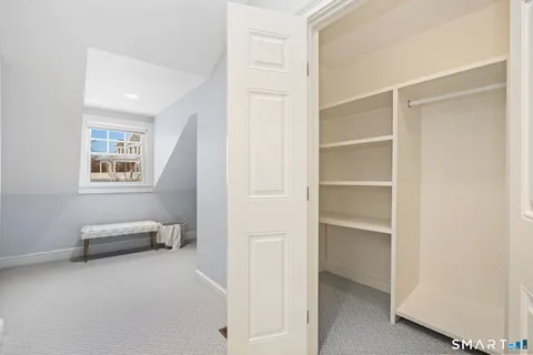 a view of bedroom with furniture and closet