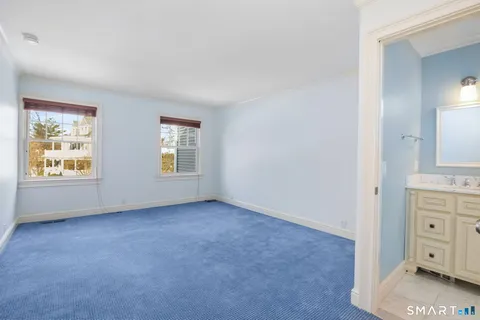 an empty room with windows and cabinet