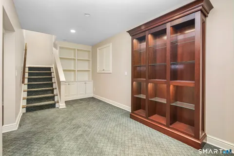 a view of an empty room with wooden floor and entryway