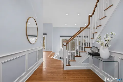 a view of entryway and hall with wooden floor