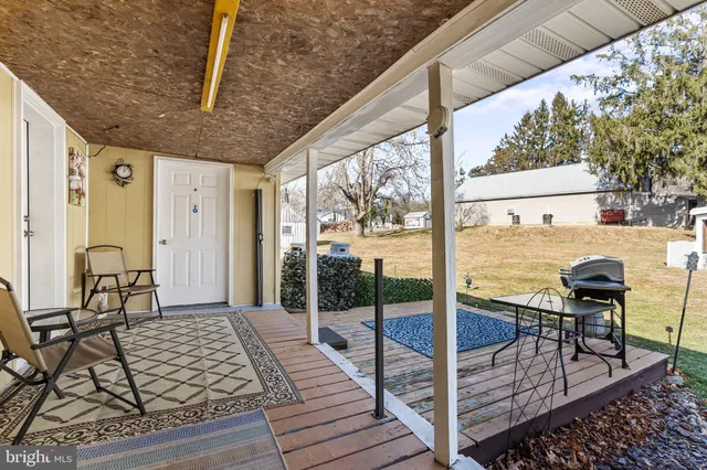 a living room with furniture a flat screen tv and a floor to ceiling window