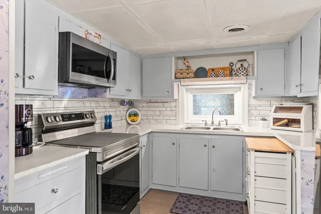 a kitchen with cabinets and stainless steel appliances
