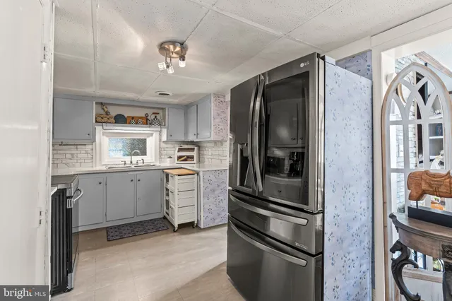 a kitchen with stainless steel appliances granite countertop a sink and a stove