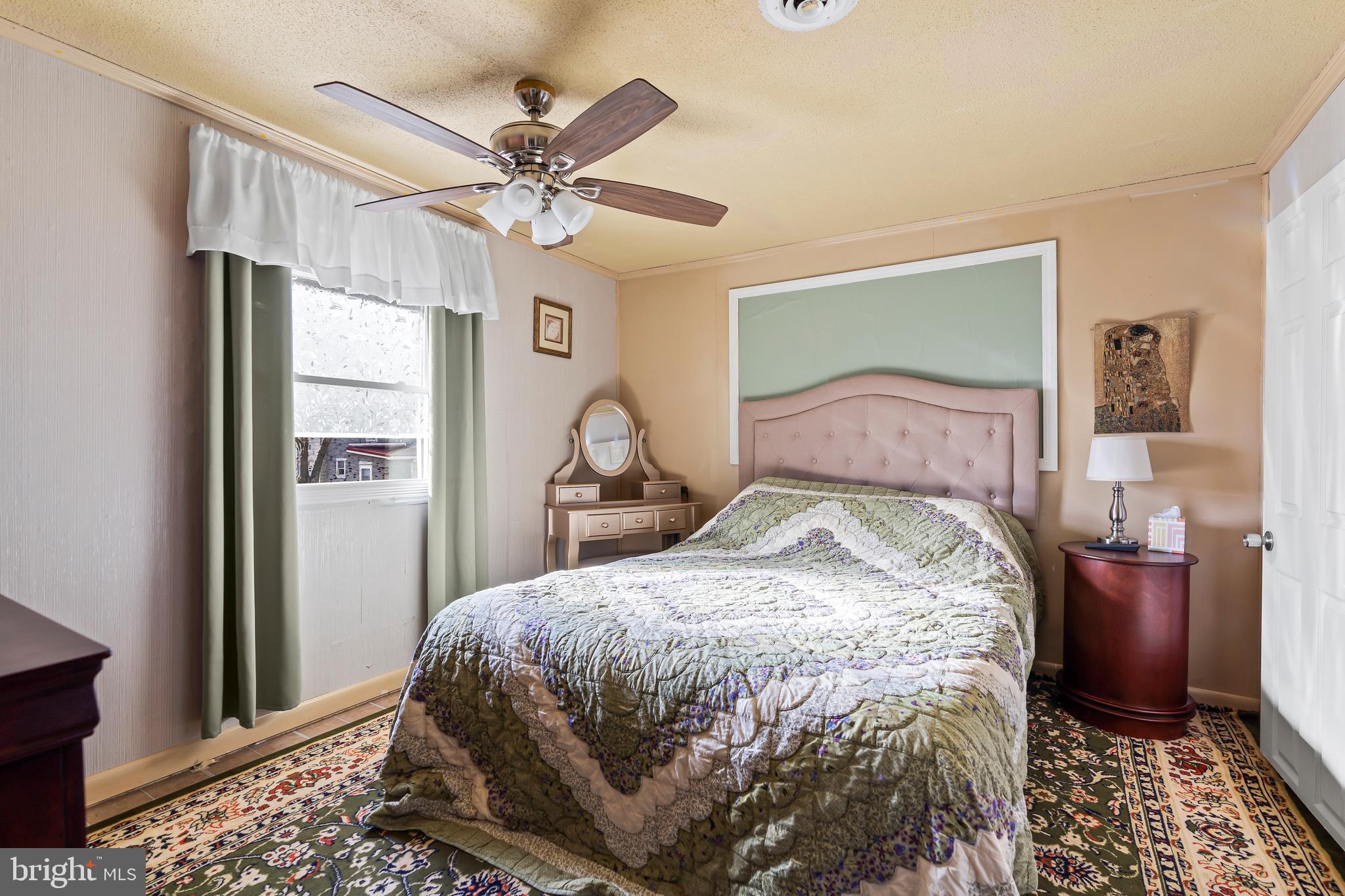 9437 Masters Road Waynesboro, PA 17268 - Photo 24 of 39 a bedroom with a bed and a chandelier