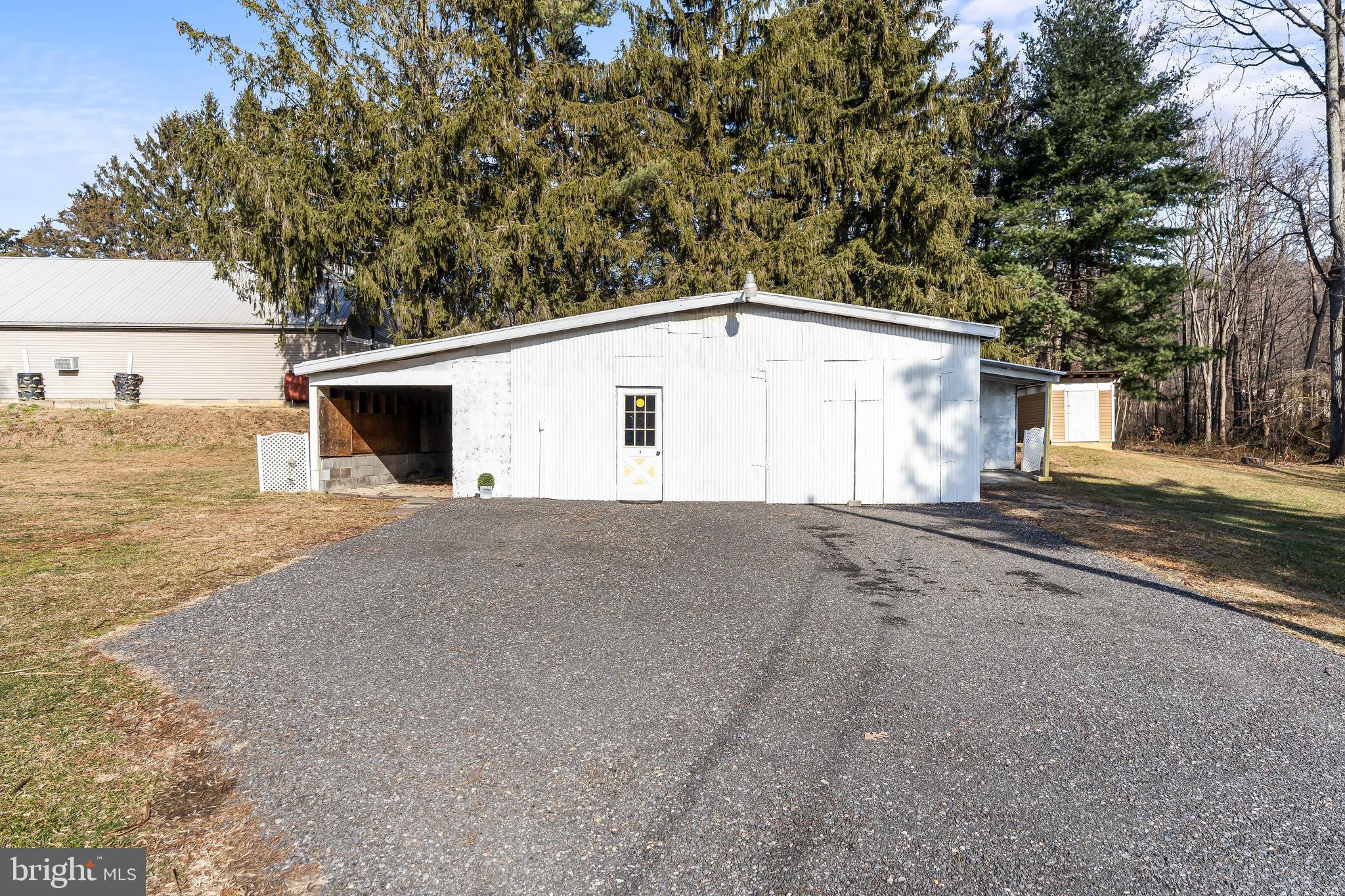 9437 Masters Road Waynesboro, PA 17268 - Photo 4 of 39 a view of a white house with a large tree