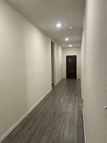 a view of hallway with wooden floor