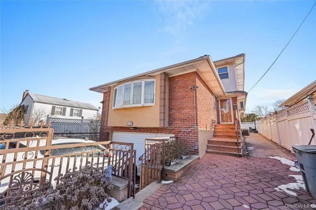 a backyard of a house with barbeque oven table and chairs