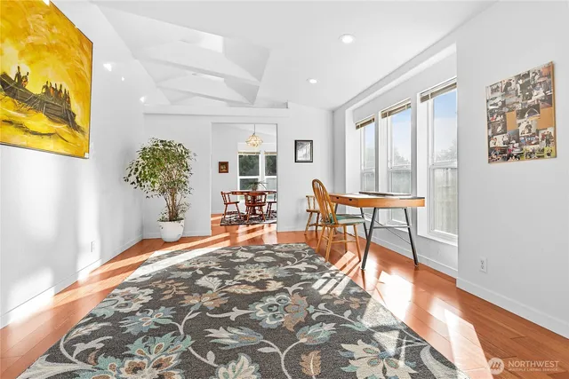 a view of a livingroom with wooden floor and a potted plant