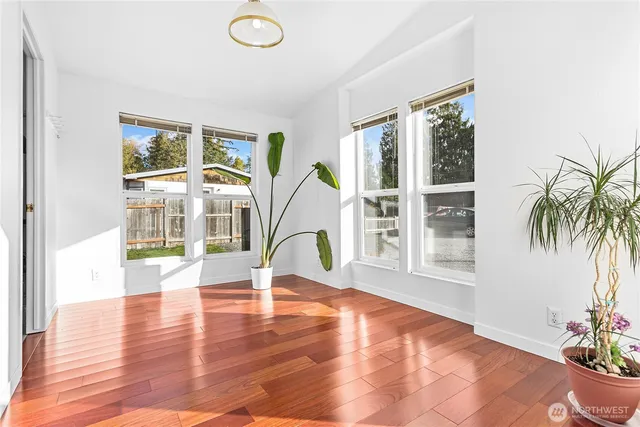 a bedroom with a bed and a flat tv screen on dresser