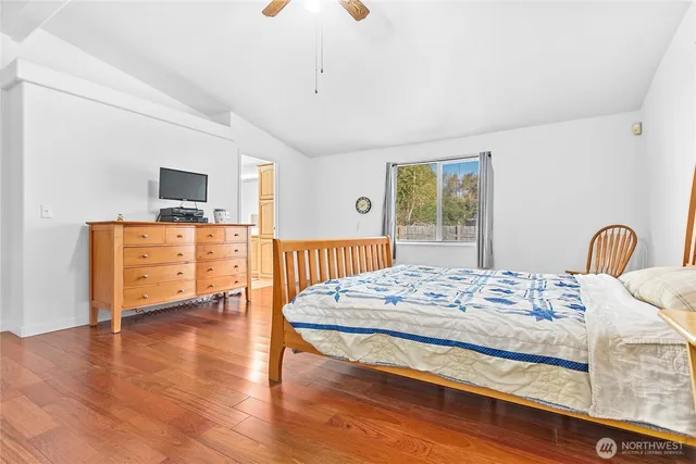 a bedroom with a bed and a view of kitchen