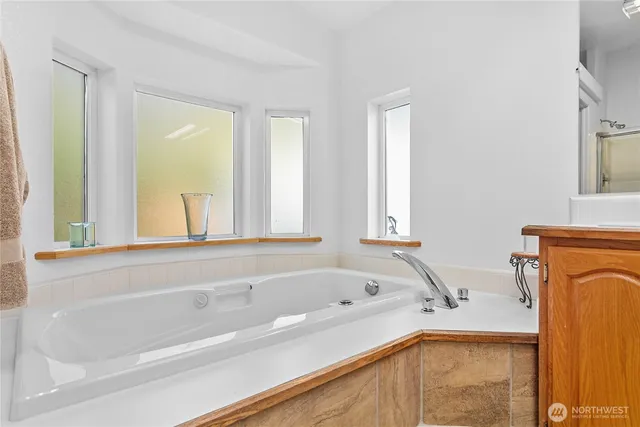 a spacious bathroom with a shower sink and mirror