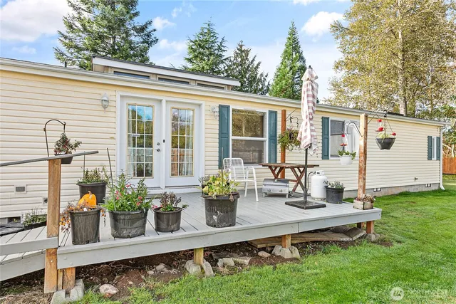 a view of backyard with small cabin and wooden fence