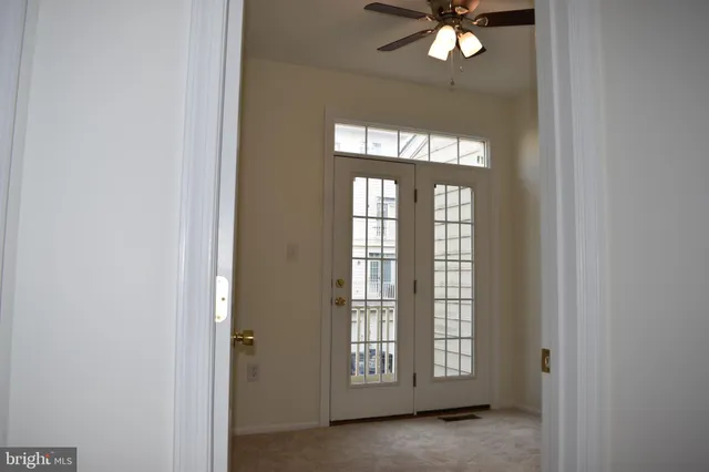 a view of a livingroom with a ceiling fan and window