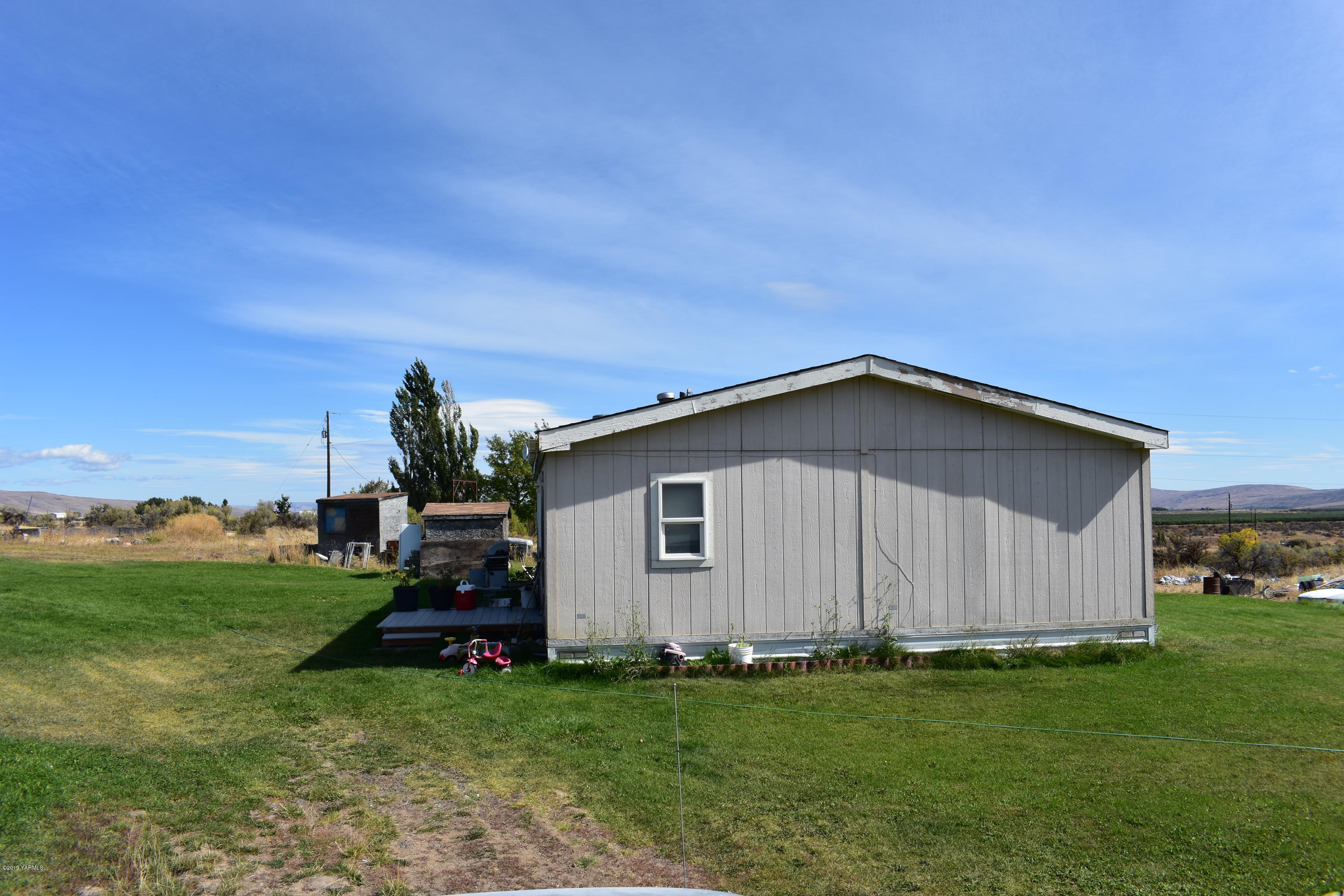 131 Mini Pines Road Yakima, WA 98903 - Photo 6 of 27 a view of a backyard with plants and a garden