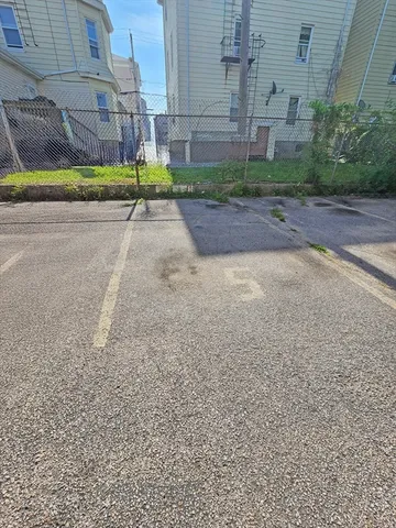 a view of a street with a brick building in the background