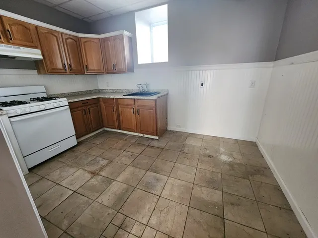 a kitchen with a stove a sink and a refrigerator