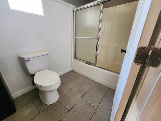 a white toilet sitting next to a sink