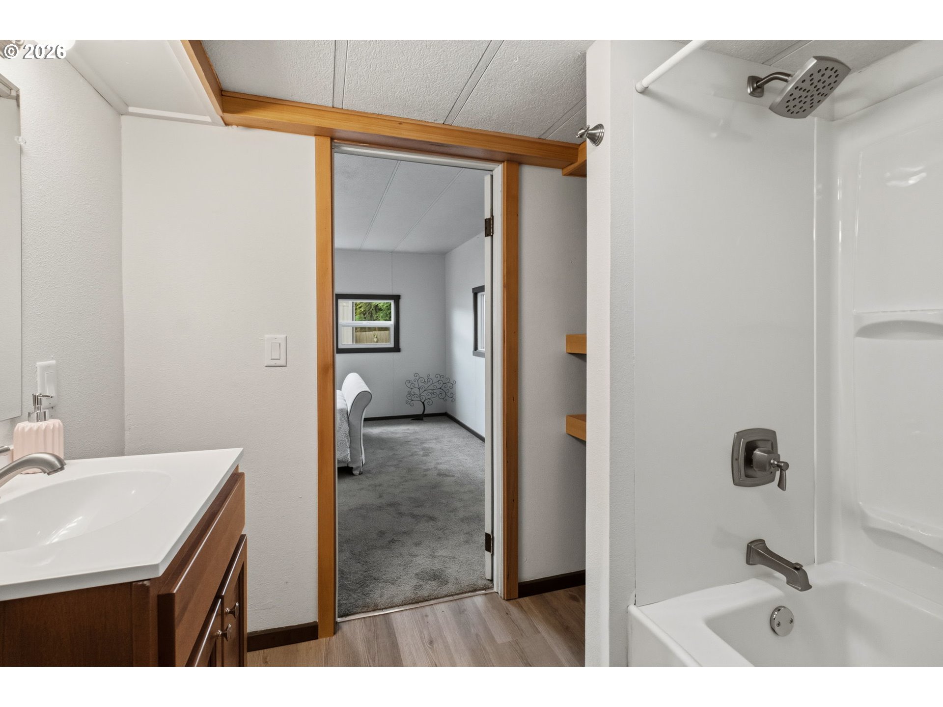 205 South 54th Street, Unit 76 Springfield, OR 97478 - Photo 16 of 41 a bathroom with a sink a mirror and a shower