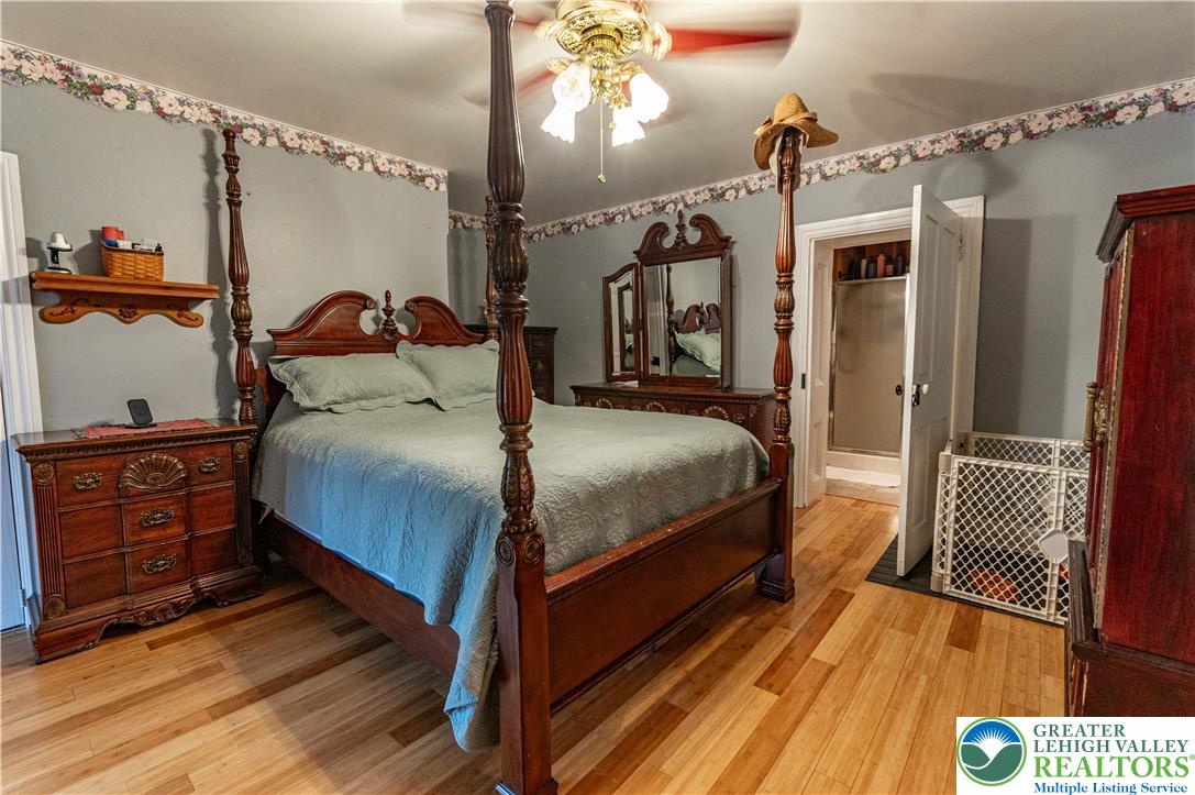 2485 Hieter Road Quakertown, PA 18951 - Photo 28 of 97 A traditional four-poster bed anchors this primary bedroom, featuring a warm wood floor and direct bath access.