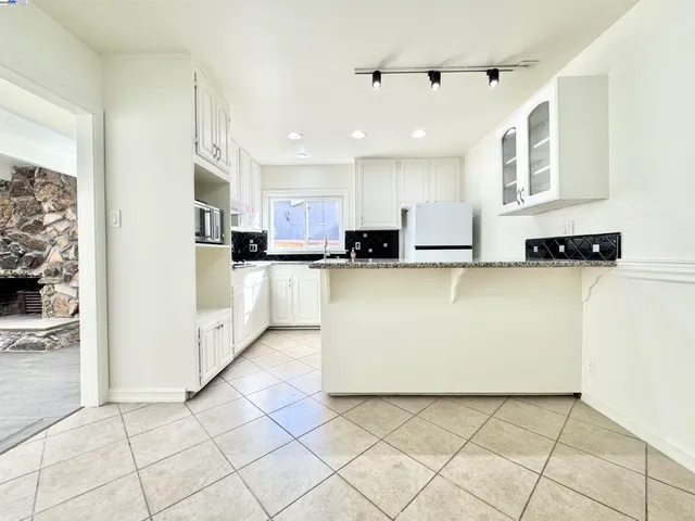 a kitchen with stainless steel appliances a refrigerator sink and microwave